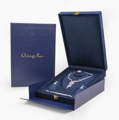 an open blue box with a necklace inside