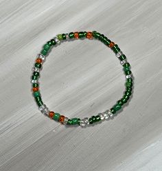 Green bead bracelet, perfect for older children and teens. stretch bracelet comes in two color combos; shiny beads or matte beads. This color variation is great for St Patricks Day. bracelet is available in several sizes. comes ready to gift with organza bag and gift card.   Mix and match multiple colors to wear together! Casual Green Stretch Bracelet With Spacer Beads, Casual Green Hand-strung Beads, Green Casual Beaded Bracelets With Spacer Beads, Casual Green Bracelets With Spacer Beads, Casual Green Beaded Bracelets With Spacer Beads, Casual Green Bracelet With Spacer Beads, Casual Green Spacer Beads Bracelet, Casual Elastic Beaded Bracelets As Gift, Casual Green Hand-strung Beaded Bracelets