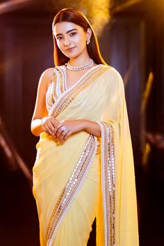 Yellow georgette saree with pearl and sequin embroidered border. Comes with unstitched blouse fabric.
Components:2
Pattern:Embroidery
Type of Work:Sequin and Pearl
Fabric:Georgette
Color:Yellow
Other Details:
Embroidered border
Note: Blouse worn by the model is not for sale, please contact the customer service to purchase the blouse separately
Occasion:Mehendi and Haldi,Sangeet - Aza Fashions Eid Georgette Pre-draped Saree With Gota Work, Embellished Georgette Pre-draped Saree For Navratri, Elegant Georgette Saree With Gota Work, Festive Gota Work Georgette Blouse, Georgette Traditional Wear With Mirror Work For Reception, Embellished Georgette Traditional Wear For Navratri, Elegant Georgette Blouse With Gota Work, Anarkali Blouse With Gota Work In Georgette, Reception Georgette Traditional Wear With Mirror Work