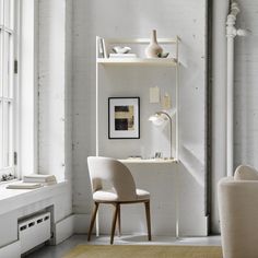 a chair and desk in a white room