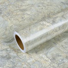 a roll of white marble paper sitting on top of a table