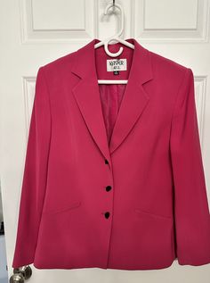 This vintage hot pink blazer features oblong buttons, sewn-in shoulder pads, and buttoned sleeves. Size 12. Condition: Perfect Materials: 100% polyester Measurements:  Pit to pit: 20 inches Shoulder to hem: 25 inches Tailored Pink Blazer With Buttons, Pink Business Blazer With Button Closure, Pink Blazer With Button Closure For Office, Pink Blazer With Button Closure For Formal Occasions, Pink Formal Blazer With Button Closure, Pink Button-up Blazer For Work, Tailored Pink Blazer With Button Closure, Pink Button-up Blazer For Office, Pink Button-up Blazer For The Office