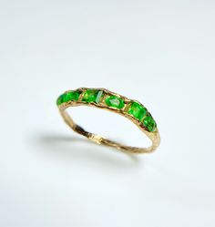 This is an exceptionally beautiful gemstone eternity band, truly one-of-a-kind. Adorned with irregularly placed 6 vivid green tsavorite garnets, each distinct in size and shape, displaying mesmerizing colors. Perfect for everyday wear, it's a unique and elegant gift choice! This ring has already been sold. Please feel free to contact me if you'd like to order a similar design. -Gems informations Vivid green tsavorite garnets X6 -Size Band thickness:  1.2- 3.6mm -Materials 14k solid gold -Packagi Unique Green Tsavorite Emerald Ring, Unique Green Tsavorite Ring, Green Multi-stone Tsavorite Jewelry, Green Tsavorite Multi-stone Jewelry, Gold Half Eternity Band, Gold Packaging, Tsavorite Garnet, Half Eternity Band, Surprise Gift