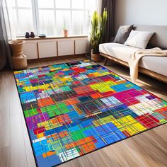 a colorful area rug in a living room with a couch and large window behind it