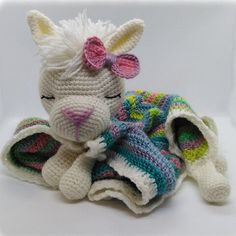 a crocheted stuffed animal laying on top of a blanket