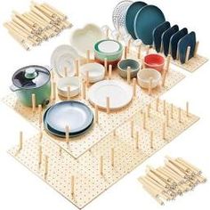 an assortment of plates and bowls on a peg board with wooden dows to hold them