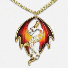 Necklace on a gold chain. The pendant is a clear glass dragon with wings in blakc, red, orange and yellow. It is accented in real gold with crystal eyes. Dragon With Wings, Dragon Necklace, Dragon Pendant, A Dragon, Gold Tone Necklace, Fantasy Jewelry, Glass Necklace, Shades Of Red, 22k Gold