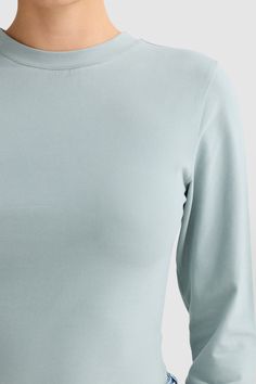 The Evie Long Sleeve T Shirt Seafoam is a wardrobe staple. Crafted from an ultra soft brushed cotton blend perfect for layering, this fitted long sleeve top has been designed to pair back with any item in your wardrobe. Designed to be fitted Long sleeves Designed in Australia. Made in China. Fitted Long Sleeve Top For Loungewear, Versatile Soft Stretch Long Sleeve Top, Versatile Long Sleeve Top With Soft Stretch, Elastane Long Sleeve Top For Layering, Stretch Long Sleeve Top With Thumbholes For Everyday, Fitted Long Sleeve Loungewear Top, Solid Color Soft Stretch Long Sleeve Tops, Everyday Cotton Stretch Long Sleeve Top, Solid Color Long Sleeve Top With Thumbholes For Loungewear