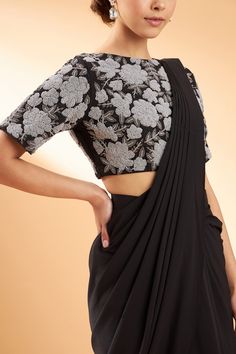 Black pre-draped saree with ruffle detail and pleated pallu. Comes with embroidered blouse.
Component: 2
Pattern: Embroidery
Type Of Work: Sequin and Beads
Neckline: Boat
Sleeve Type: Half
Fabric: Moss Crepe
Color: Black
Other Details: 
Sequin and bead embroidered blouse
Closure: Side zip
Occasion: Destination Wedding - Aza Fashions Formal Blouse With Mirror Work In Traditional Drape, Anarkali Evening Blouse With Traditional Drape, Anarkali Blouse Piece For Evening With Traditional Drape, Evening Saree Blouse With Cutdana, Evening Semi-stitched Blouse With Cutdana, Evening Anarkali Blouse With Traditional Drape, Floor-length Evening Blouse With Cutdana, Traditional Georgette Blouse For Evening, Traditional Evening Blouse In Georgette