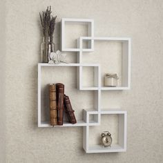 Add a fun and playful flair to your living space with the Danya B. intersecting cube shelves – white. Intersecting cubes create an alluring geometric wall art that doubles as a functional shelf for books, photographs, foliage, and other home décor. The versatile white finish allows easy integration to any color motif. Mount the Danya B. intersecting cube shelves – white in contemporary living rooms or bedrooms to create a fun and modern statement room! Danya B. is a registered trademark of Danya Shelf Cube, Cube Wall Shelf, White Shelf, Small Shelf, Cube Shelves, Wall Shelves Design, Large Shelves, Floating Wall Shelves, White Laminate