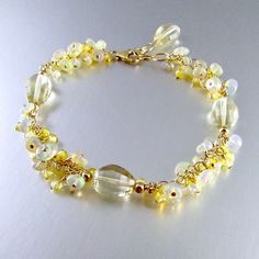 "This fresh lemon yellow quartz bracelet is paired up with Ethiopian opals that has a slight yellow cast to them. I have also sprinkled in sparkling yellow zircon rounds. All gold filled components are used. The lemon quartz measure approximately 12x9mm. The opals measure 5mm. and the zircon measure 2.5mm. The bracelet measures 7 1/2\" in length 9not including the extender chain) and will fit wrists from 6 3/4\" to 7 1/2\" comfortably." Gold Beaded Bracelets With Gemstone Accents, Elegant Yellow Bracelets With Gemstone Beads, Elegant Yellow Gemstone Beads Bracelets, Elegant Yellow Beaded Bracelets With Gemstone Beads, Elegant Yellow Gemstone Beaded Bracelets, Elegant Gold Citrine Crystal Bracelet, Yellow Citrine Gemstone Bracelets, Elegant Yellow Beaded Bracelets For Jewelry Making, Elegant Yellow Beaded Crystal Bracelet