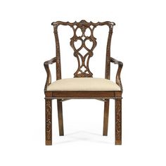 an ornate wooden chair with beige upholstered seat and armrests, against a white background