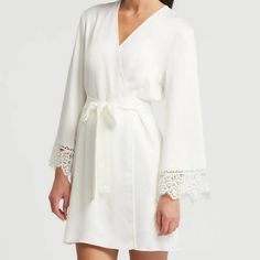 Anthropologie Rya Collection Rosey Cover Up In Ivory Satin. Short Style Robe With Side Pockets. Ties At Waist. Lace Trimmed Sleeves. New With Tag. Underarm To Underarm Measured Flat Across The Back Is 20" And Stretches To 22". Hip To Hip Measured Flat Across The Back Is 24" And Stretches To 26". Length Is 34" Measuring From Neckline To Hem At The Back. 100% Polyester. Smoke Free, Pet Free Home. Chic V-neck Sleepwear For Wedding Night, Elegant Beige V-neck Sleepwear, Elegant Spring Sleepwear For Wedding Night, Elegant Spring Wedding Night Sleepwear, Elegant Lace Trimmed Summer Sleepwear, Elegant Summer Sleepwear With Lace Trim, Elegant Lace Trim Sleepwear For Summer, Elegant Cream Sleepwear, Chic Sleepwear With Lace Trim