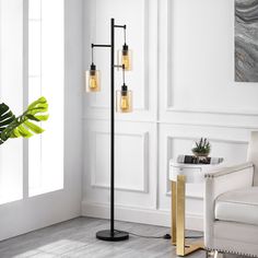 This 3-light tree floor lamp features clean lines and a simple, minimalist design that complements your industrial and farmhouse decor in the living room or bedroom. It has a 65" tall frame that's made from metal with a sleek matte black finish, and it stands on a rounded base. The clear cylindrical glass shades showcase an open bulb base that each accommodates a bulb up to 60 W (not included). Plus, this floor lamp has a foot switch on the base that makes it easy to turn the light on and off. GETLEDEL 65-in Black Multi-head Floor Lamp | PT-050700 Farmhouse Floor Lamps, Pc Ideas, Lamp With Glass, Manly Decor, Farmhouse Room, Tree Floor Lamp, Office Lamp, Unique Floor Lamps, Room Styles