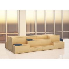 an empty couch sitting in front of large windows