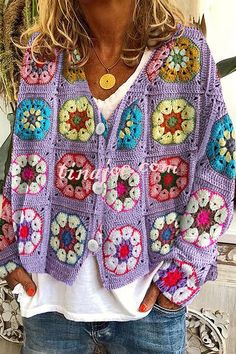 a woman wearing a purple crocheted sweater with flowers on the front and sides