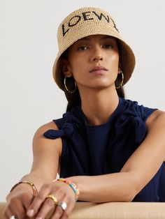 Made in collaboration with Paula's Ibiza, Loewe's bucket hat is perfect for your next tropical vacation. It's woven from a raffia-blend, embroidered with the logo and has a substantial brim to shield your face from the harsh sun. Raffia Bucket Hat, Loewe Paula's Ibiza, Porter Bag, Loewe Logo, Designer Belts For Women, Soft Accessories, Summer Style Guide, Dress Flats, Designer Belts