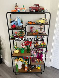 a shelf filled with lots of toy cars and flowers