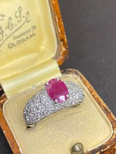 14ct white gold ruby and diamond cocktail ring  This stunning ring boasts a proud set oval 1.16ct natural ruby (8x6) complimented by a tapered pave set diamond band comprising of 1.02ct natural cut diamonds  Ring size: M(UK), 6(USA) Ring weight: 6.67grams  Sale Price: £1210.00 Insurance replacement price: £2850.00 All articles come presented in a gift box Gia Certified Oval Ruby Ring, Classic Oval Diamond Gemstones, Classic Oval Platinum Gemstones, Oval Ruby Ring With Diamond, Classic Oval Gemstone With Center Stone, Oval Ruby Ring With Diamond Cut In Platinum, Classic Oval White Gold Gemstones, Heirloom Oval Ruby Ring Gia Certified, Gia Certified Heirloom Oval Ruby Ring