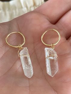 "These raw crystal quartz huggies are the sweetest little hoops of your dreams. Wear in your second hole or first, you choose! They're lightweight and beautiful as a single earring or layered with other earrings. The crystal moves freely on the ring and no two crystals are alike! QUARTZ GEMSTONE PROPERTIES Quartz is the power stone that invites you to step into your power in every moment. It amplifies energy and intention. ▲ Choose 14k gold fill or sterling silver hoops ▲ Raw crystal quartz *all Nickel-free Hoop Crystal Earrings As Gift, Clear Hoop Earrings For Pierced Ears As Gift, Clear Small Hoop Earrings Gift, Clear Small Hoop Jewelry For Gifts, Clear Small Hoop Jewelry Gift, Clear Small Hoop Earrings As Gift, Clear Hoop Jewelry As A Gift, Clear Hoop Jewelry For Gifts, Clear Hoop Jewelry For Gift