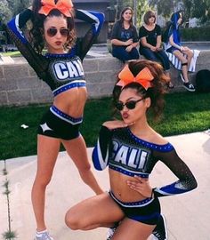 two cheerleaders are posing for the camera