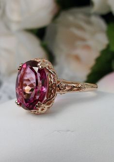 "Natural Pink Topaz Ring Edward Design#70 Custom Made Inspired by Edwardian jewelry of the early 1900s, I now offer this lovely Antique reproduction ring in sterling silver rose gold plated. This gorgeous ring is set with a stunning Natural Pink Topaz gemstone. This genuine pink topaz has excellent color and clarity. The oval cut 3.41ct Topaz is 12mm (9/16th of an inch) Long by 10mm Wide (3/8th\"). The ring sits 6mm off the finger. The inside of the band s marked 925 for sterling. Notice the bea Pink Gem Ring, Pink Gold Rings, Pink Topaz Ring, Pink Stone Rings, Unique Rings Vintage, Edwardian Jewelry, Pink Topaz, Ring Rose Gold, Pink Gemstones