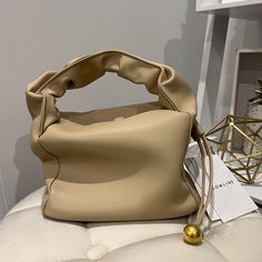 Real Smooth Leatherbeige Colorgolden-Tone Hardware H 5.5 In.(Without Handle)/W 8 In./D 4.5 In. Modern Gold Rectangular Bucket Bag, Trendy Gold Top Handle Bucket Bag, Chic Cream Shoulder Evening Bag, Everyday Use Bucket Shoulder Bag With Pearl Handle, Beige Shopping Bag With Pearl Handle, Everyday Bucket Shoulder Bag With Pearl Handle, Beige Crossbody Evening Bag With Detachable Handle, Beige Bags With Pearl Handle For Shopping, Daily Use Bucket Shoulder Bag With Pearl Handle