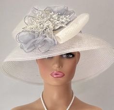 The featured hat is a  silver straw lightweight mesh hat.  The band around the hat is a bright sparkly silver bling strip. The hat is adorned with a  silver crinoline design. In the center of that design is a metal framed flower with wired clear rhinestones. The hat is so dramatic and evocatively romantic it's a must have for any woman who loves hats. Creating the look that suits you best comes from turning the hat on your head creating a different look with each twist till you find the look you love. This classic one of a kind hat made by Letty is a beautiful church hat or a Kentucky Derby Hat.   Also perfect  for  an Easter Hat, Tea Party hat,Wedding Party Hat, Fancy Dress hat, Downton Abby Hat and other special occasions. Brim:   6.5"" curved Rise:   4" Size:    Internal Draw String to Audrey Hepburn Hat, Hat Tea Party, Easter Hat, Downton Abby, Easter Hats, Hat Wedding, Church Hat, Tea Party Hats, Silver Bling