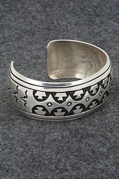 This sterling silver bracelet was made by Navajo silversmith Rosita Singer. The back is signed T&R Singer and stamped sterling.Size: 5 1/2" (will fit a 6 3/4" wrist)Gap: 1 1/4"Length: 1"Free shipping on all orders! We ship with USPS and always include tracking. All orders ship within a day of payment.Returns are accepted up to 30 days after you receive your order. Just send us a message. Our shop offers cash back or store credit. The item must be returned in new condition. Adjustable Silver Southwestern Bracelet, Southwestern Silver Cuff Bracelet With Inlay, Adjustable Silver Southwestern Bangle, Adjustable Southwestern Silver Bangle, Silver Stamped Southwestern Bracelets, Silver Southwestern Stamped Bracelets, Southwestern Silver Engraved Cuff Bracelet, Handmade Southwestern Silver Bracelets, Sterling Silver Inlay Bracelets In Silver Color