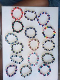 a group of bracelets sitting on top of a white board