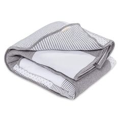 three folded blankets stacked on top of each other in grey and white striped fabric,