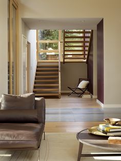 a living room filled with furniture and a stair case