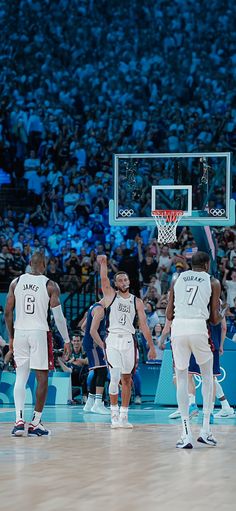 the basketball players are getting ready to play against each other in front of an audience