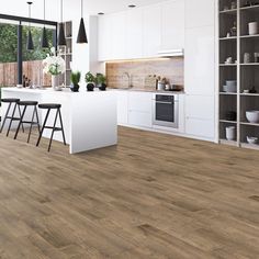 a kitchen with wood floors and white cabinets