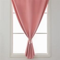 a pink curtain hanging in front of a window