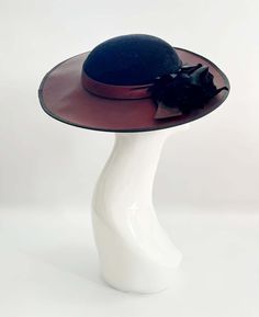 "Classic vintage hat. Perfect for Ascot, weddings, special occasions, very elegant. Comes with elastic to hold hat in place. Condition: vintage perfect Colour: black and dark burgundy Label: Made in England Material: polyester Size: M inner circumference aprox. 21.5-22 inches, circumference 44\"\" *Please note all hats come securely packed in a box *All our vintage items come in clean and best condition possible *Please note all hats come securely packed in a box *All our vintage items are top q Retro Fascinator For Kentucky Derby Evening, Retro Evening Fascinator For Kentucky Derby, Retro Fascinator For Evening At Kentucky Derby, Vintage Top Hat With Short Brim For Party, Retro Brimmed Fascinator For Parties, Fitted Brimmed Costume Hat For Evening, Fitted Wide Brim Costume Hats And Headpieces For Evening, Fitted Wide Brim Costume Hat For Evening, Vintage Party Top Hat