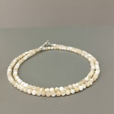 Product Description: Item Code: SGH-1056 Stone Name: Mother of Pearl Size: 3mm Shape: Smooth Round Color: White  Length: 18 Inches (Approx.) Weight: 34Cts (Approx.) Lock: 925 Lobster Clasp **All natural gemstones vary in color and pattern. We try our best to make our photos represent the real products in person. ** **All Customization Facility Is Available as per your Requirement Also in Other stones. ** **Bulk Order also available** **Please feel free to contact for any further queries** Minimalist White Beaded Necklaces With Faceted Beads, Minimalist White Beaded Necklace With Faceted Beads, Minimalist Faceted Round Beaded Necklaces, White Pearl Rondelle Necklace With Gemstone Beads, White Pearl Long Necklace With Gemstone Beads, Elegant White Faceted Beaded Necklaces, White Pearl Necklace With Rondelle Gemstone Beads, Pearl White Mother Of Pearl Necklace With Round Beads, White Beaded Mother Of Pearl Necklace