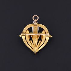 Iris, the Greek goddess of the rainbow, was said to bridge earth and heaven, and the flowers that now bear her name, were planted on graves to help her guide the souls to heaven. This antique 14k gold brooch/pendant by the renowned Krementz & Co. (circa 1910-1920) features an iris adorned in pale pink and green enamel, accented by two glittery diamonds and a single dog tooth pearl. The piece measures 1.1 inches from top to bottom by 1 inch wide, and it is in very good condition with a small bit Art Deco Yellow Gold Collectible Brooches, Art Nouveau Yellow Gold Brooches Gift, Art Nouveau Yellow Gold Collectible Brooches, Art Deco Yellow Gold Hallmarked Brooches, Art Deco Pendant Brooches As Gifts, Gold Brooch, Dog Teeth, Gold Brooches, Enamel Flower