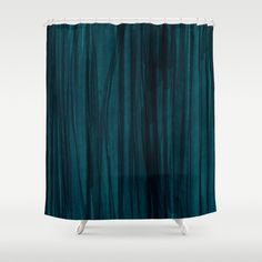 a blue shower curtain with dark green curtains on the side and white legs in front