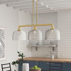 an image of a kitchen setting with food on the table and lights hanging from the ceiling