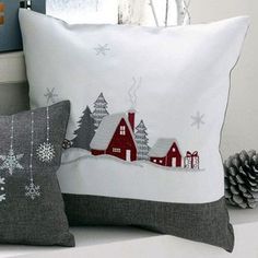 two pillows on a shelf with christmas decorations