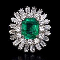 an emerald and diamond cluster ring