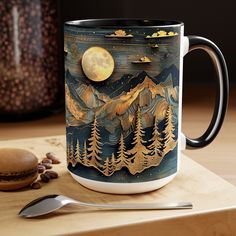 a coffee mug sitting on top of a wooden table next to a spoon and cup