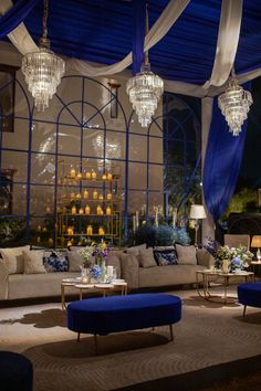 a living room filled with furniture and chandeliers