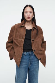 This season, the COS womenswear designers celebrate the foundations of the modern wardrobe. This collared jacket is crafted from supple suede that will age beautifully with wear and is bonded internally with neoprene, lending weight and structure. The tonal horn buttons complement the rich chocolate hue of the hide, which is echoed on the matching culottes. Relaxed fitButton closureCOS supports responsible manufacturing via the Leather Working Group  Shell: 100% Suede. Bonded lining: 95% Polyester, 5% Elastane. Excluding trims / Spot clean Back length of size EU 36 is 71.1cm / Model wears a size EU 36 Suede Jacket Women, Culotte Shorts, Easy Outfits, Party Mode, Suede Mini Skirt, Brown Outfit, Modern Wardrobe