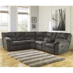 a living room with a sectional couch and two end tables