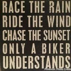 a sign that says race the rain ride the wind chase the sunset only a biker understands