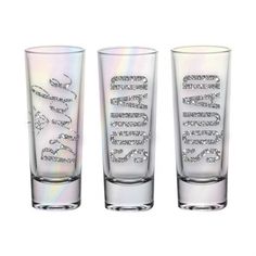 three shot glasses with the word love on them, all in iridescent colors