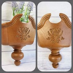 a wooden vase with flowers in it sitting on top of a white table next to a planter