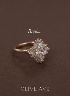 an engagement ring with two pear shaped diamonds on it and the words byton above it